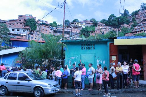 Residents waiting in line to enter Government sponsored supermarket in Petare, an slum in Caracas. 