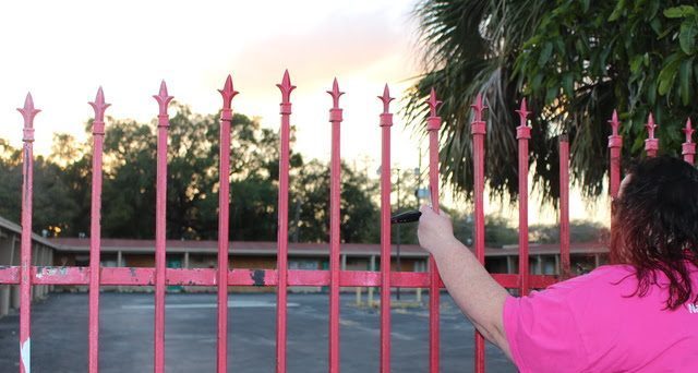 Alles standing outside an abandoned hotel, where she once lived for several months with her trafficker in room 21