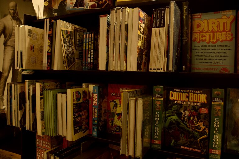 A shelf of books about comics.